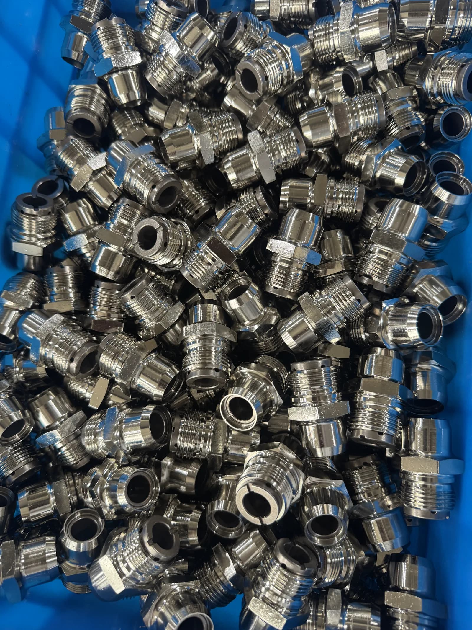 Close real factory view of machined threaded cotton picker spindle components